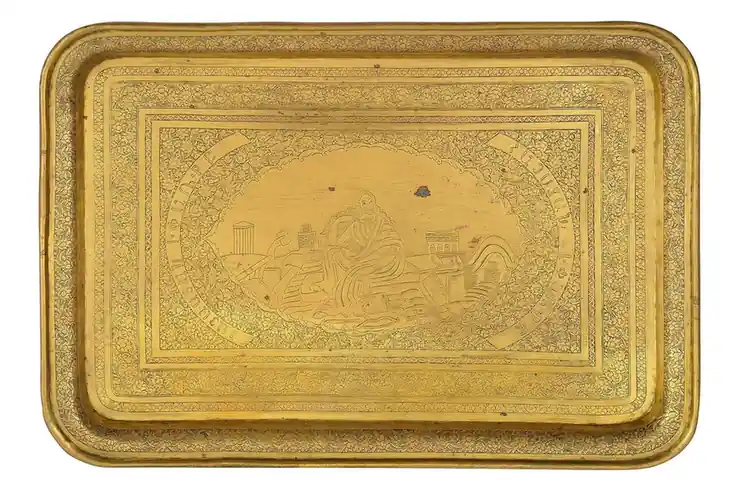 A rectangular brass tray with a raised rim and a finely engraved scene across its face
